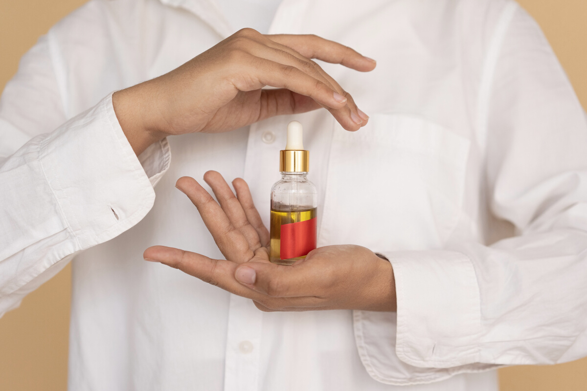 Woman Holding A Bottle Of Essential Oil